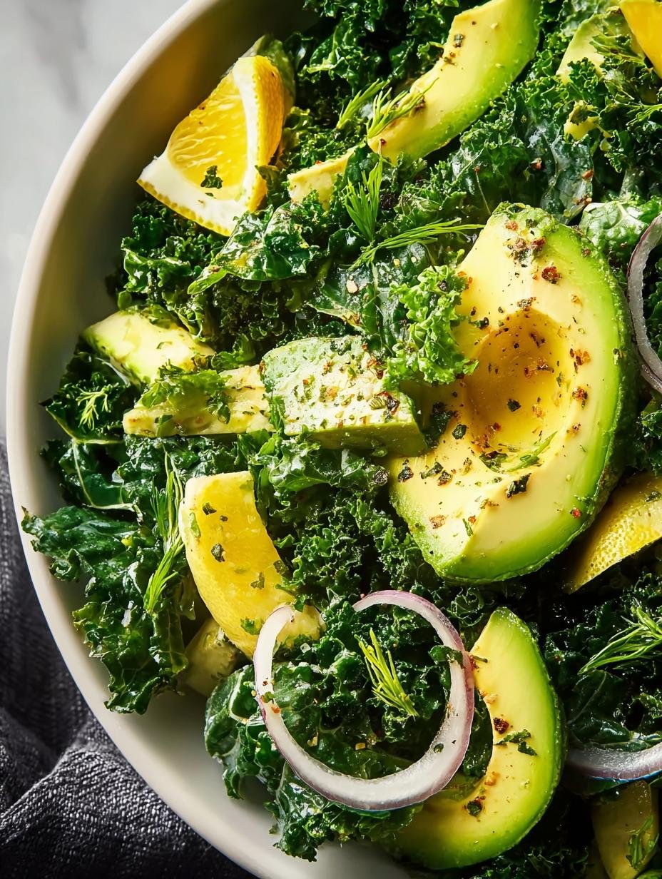 Close-up of a serving of Avocado Lemon Kale Salad, highlighting the creamy avocado pieces and vibrant green kale, a fresh delight in 15 minutes